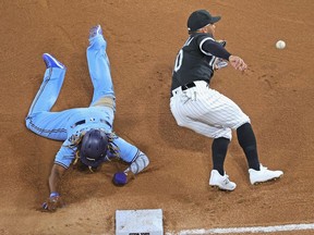 Vladimir Guerrero Jr. of the Toronto Blue Jays advances to third base on a wild pitch as Yoan Moncada of the Chicago White Sox takes the late throw in the 6th inning at Guaranteed Rate Field on June 10, 2021 in Chicago, Illinois.