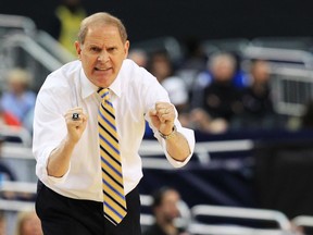 Head coach John Beilein of the Michigan Wolverines reacts in the second half against the Florida Gators during the South Regional Round Final of the 2013 NCAA Men's Basketball Tournament at Dallas Cowboys Stadium on March 31, 2013 in Arlington, Texas.