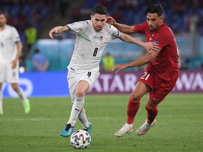 Italy's midfielder Jorginho (L) and Turkey's midfielder Irfan Can Kahveci vie for the ball during the UEFA EURO 2020 Group A football match between Turkey and Italy at the Olympic Stadium in Rome on June 11, 2021.
