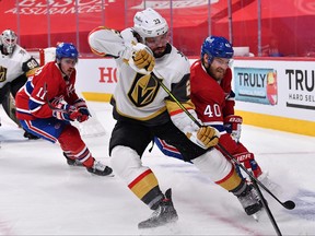 Alec Martinez of the Vegas Golden Knights and Joel Armia of the Montreal Canadiens battle for the puck during the second period in Game 6 of the Stanley Cup semifinals at Bell Centre on June 24, 2021 in Montreal.