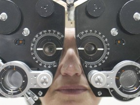 A woman has her eyes checked at an optometrist's office in this file photo.