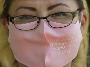 Blaire Preteau wears a face mask to protect against COVID-19 while working in Edmonton's Borden Park, Saturday June 12, 2021.