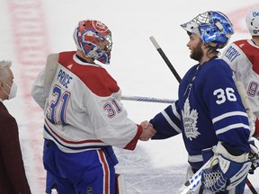 Toronto Maple Leafs goalie Jack Campbell (36) shakes hands with Montreal Canadiens goalie Carey Price (31) after Montreal won 3-1 in game seven of the first round of the 2021 Stanley Cup Playoffs at Scotiabank Arena.