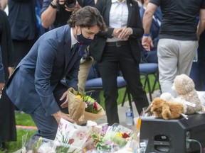 Prime Minister Justin Trudeau lays flowers at the London Mosque prior to a Tuesday vigil being held in memory of the Afzaal-Salman family, in London, Ont., Tuesday, June 8, 2021.