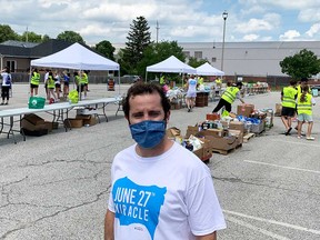 Matt Hernandez, an organizer of the June 27th Miracle food drive, stands in front of volunteers at the Gino and Liz Marcus Community Complex in Windsor on June 27, 2021.