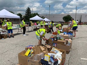Volunteers organize non-perishable grocery donations at the Gino and Liz Marcus Community Complex - one of the drop-off points for the June 27th Miracle food drive in Windsor, on June 27, 2021.