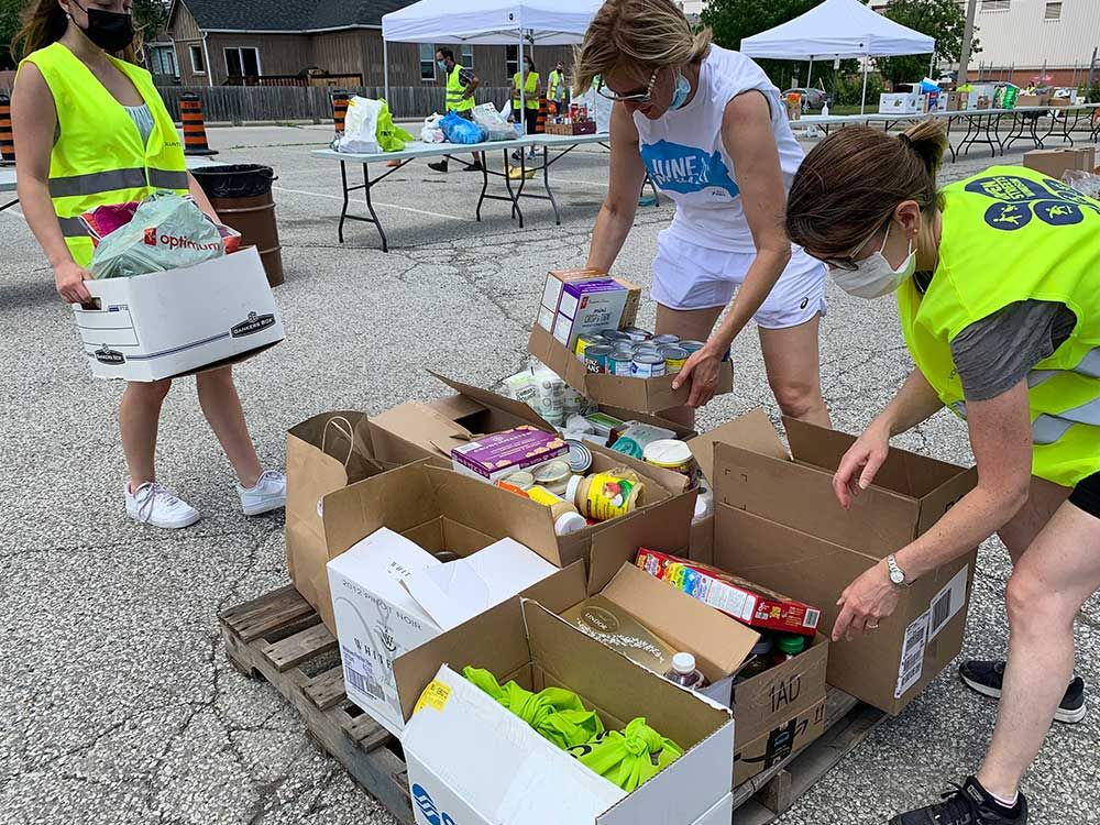 Volunteers organize non-perishable grocery donations at the Gino and Liz Marcus Community Complex - one of the drop-off points for the June 27th Miracle food drive in Windsor, on June 27, 2021.