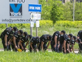 Eleven London police officers search for evidence along the southbound lanes of Hyde Park Road near South Carriage Road in northwest London as part of the investigation into a crash Sunday night that killed three adults and a teen who were walking. Photograph taken on Monday June 7, 2021 (Mike Hensen/The London Free Press)