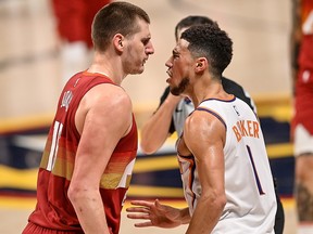 Nikola Jokic of the Denver Nuggets gets in the face of Devin Booker of the Phoenix Suns during Game 4 of the Western Conference second-round playoff series at Ball Arena on June 13, 2021 in Denver.