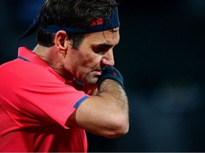 Switzerland's Roger Federer reacts as he plays against Germany's Dominik Koepfer during their men's singles third round tennis match on Day 7 of The Roland Garros 2021 French Open tennis tournament in Paris on June 5, 2021.