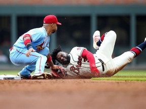 Atlanta Braves left fielder Abraham Almonte is tagged out on a steal attempt by St. Louis Cardinals second baseman Edmundo Sosa in the second inning at Truist Park.