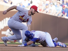 Chicago Cubs second baseman Eric Sogard is safe at second base with a double as St. Louis Cardinals shortstop Paul DeJong makes a late tag during the third inning at Wrigley Field.