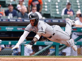 Chicago White Sox third baseman Yoan Moncada dives in safe at home in the fourth inning against the Detroit Tigers at Comerica Park.