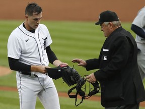 Detroit Tigers starting pitcher Tarik Skubal gets some of his gear checked by umpire Joe West during the second inning against the St. Louis Cardinals at Comerica Park.
