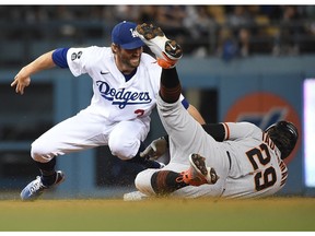 San Francisco Giants center fielder Mike Tauchman is out at second against Los Angeles Dodgers left fielder Chris Taylor in the ninth inning at Dodger Stadium.