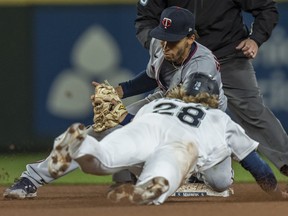 Minnesota Twins shortstop Andrelton Simmons tags out Seattle Mariners designated hitter Jake Fraley as he tries to steal second base during the seventh inning of a game at T-Mobile Park.