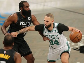 Boston Celtics shooting guard Evan Fournier controls the ball against Brooklyn Nets shooting guard James Harden during the first quarter of game five of the first round of the 2021 NBA Playoffs at Barclays Center.