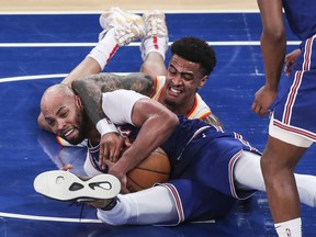 New York Knicks center Taj Gibson and Atlanta Hawks forward John Collins fight for a loose ball in the third quarter during game five in the first round of the 2021 NBA Playoffs at Madison Square Garden.