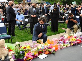 Canadian Prime Minister Justin Trudeau lays flowers at a vigil outside the London Muslim Mosque organized after four members of a Canadian Muslim family were killed in what police describe as a hate-motivated attack in London, Ontario, Canada, June 8, 2021.