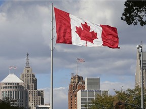 The Great Canadian flag in Downtown Windsor is shown in the foreground with Detroit seen just across the Detroit River on Thursday, October 8, 2020. Canada Border Services Agency employees will be in a strike position on Aug. 6.