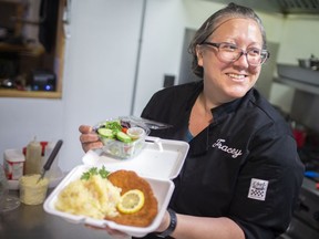 Tracey Stiller, a cook at Heimat on Drouillard Road, prepares a pork schnitzel with a hot potato salad and side salad, on Wednesday, June 2, 2021.  The Heimat hosts the Bavarian Village during the Carrousel of Nations which will again be a take-out only event.
