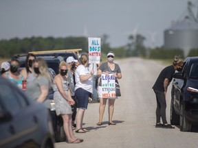 Animal activists hold a rally Saturday, June 5, 2021, on Lions Club Drive in Belle River where they allege dogs are being held in poor conditions, on