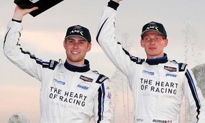 Roman De Angelis of Belle River (right) and co-driver Ross Gunn (left) hold up their trophies after competing in the GT Daytona class of the Detroit Grand Prix on June 12, 2021.