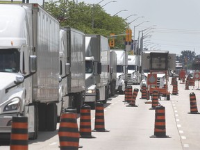 A long line of trucks are shown in construction zone on Huron Church Road in Windsor on Monday, June 21, 2021. At one point traffic as backed up to highway 401.
