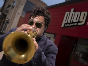 Singin' the pandemic blues. Trumpet player Russ Macklem, a member of the group United, is pictured outside Phog Lounge on Wednesday, June 9, 2021. COVID-19 has devastated the local live music scene.