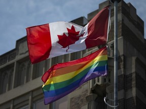 The Pride flag flies alongside the Canadian flag at Walkerville Collegiate Institute on Thursday, June 10, 2021.