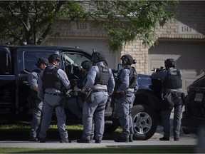 Members of the Windsor Police Emergency Services Unit are seen attempting to detain a suspect from a house on Dobrich Street at the end of Curry Avenue in the South Cameron neighbourhood, on Wednesday, June 23, 2021.   (DAX MELMER/Windsor Star).