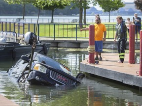 Crews with Coxon's Towing and LaSalle Towing and Recovery pull a vehicle that was fully submerged at the bottom of the LaSalle Marina on Monday, June 28, 2021.  A boater was attempting to launch a boat when his vehicle rolled backwards into the water. The incident occurred shortly after noon Monday and took until about 5 p.m. to return the land vehicle back to terra firma.