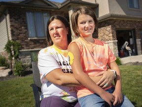 Dana Schmidt and Ameleah Schmidt, 9, one of Dana's three children, and who was diagnosed with type 1 diabetes in January, are pictured outside their home in Amherstburg, on Wednesday, June 16, 2021.  Dana Schmidt organized an outdoor fundraiser for the Juvenile Diabetes Research Foundation on Sunday and when dozens of people showed up she was ticketed by Windsor Police for having too large a gathering.