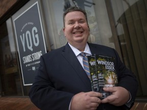 Gordon Orr, CEO of Tourism Windsor Essex Pelee Island, holds this year's official visitor guide, outside their downtown office on Wednesday, June 2, 2021.