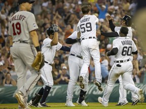 Miguel Cabrera of the Detroit Tigers hits a blooper single to drive in the winning run against the Minnesota Twins and celebrates with teammates during game two of a double header at Comerica Park on July 17, 2021 in Detroit, Michigan. Detroit defeated Minnesota 5-4 in extra innings.