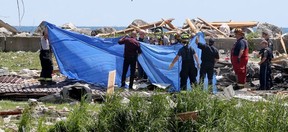 Body removal specialists, OPP, Leamington firefighters and provincial fire investigators prepare to remove one of the deceased on July 13, 2020, the day after a Marentette Beach home in Leamington was flattened in an explosion and fire. Two people were found dead at the scene.