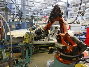 A KUKA AG robotic arm prepares to install the cockpit section of a Daimler AG Mercedes-Benz S-Class sedans on the assembly line at the Mercedes-Benz plant of Daimler AG on January 24, 2014 in Sindelfingen, Germany.