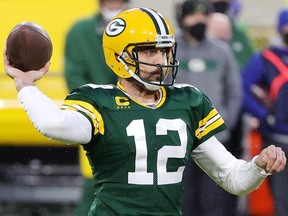 Aaron Rodgers of the Green Bay Packers throws a pass in the first half against the Los Angeles Rams at Lambeau Field on January 16, 2021 in Green Bay, Wisconsin.