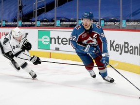 Mikey Anderson, left, of the Los Angeles Kings tries to stop Gabriel Landeskog of the Colorado Avalanche in the second period at Ball Arena on March 12, 2021 in Denver, Col.