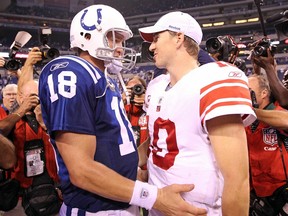 Eli Manning of the New York Giants and Peyton Manning of the Indianapolis Colts embrace following the Colts 38-14 win at Lucas Oil Stadium on September 19, 2010 in Indianapolis.
