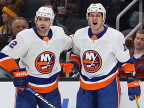 Mathew Barzal, right, of the New York Islanders celebrates with Nick Leddy after scoring a goal against the Boston Bruins during the second period at TD Garden on Dec. 19, 2019 in Boston.