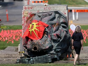 A group of protesters damaged statues of Queen Victoria and Queen Elizabeth, located on the grounds of the Manitoba Legislative Building and Government House, respectively, in Winnipeg, Thursday, July 1, 2021.