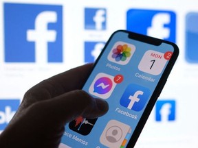 This file photo illustration photo shows a Facebook App logo displayed on a smartphone in Los Angeles, March 1, 2021.