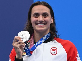 Canada's Kylie Masse poses with her medal on the podium after the final of the women's 100m backstroke swimming event during the Tokyo 2020 Olympic Games at the Tokyo Aquatics Centre in Tokyo on July 27, 2021.
