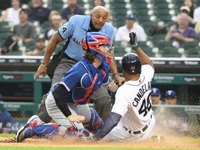 Texas Rangers catcher Jonah Heim tags out Detroit Tigers designated hitter Jeimer Candelario at home during the fourth inning at Comerica Park.
