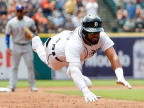 Detroit Tigers second baseman Willi Castro dives into third base after hitting a triple against the Texas Rangers in the second inning at Comerica Park.