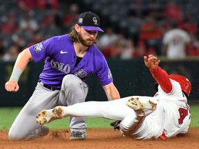Colorado Rockies shortstop Brendan Rodgers tags Los Angeles Angels shortstop Jose Iglesias out on a steal attempt of second base during the fourth inning at Angel Stadium.