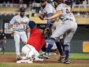 Minnesota Twins designated hitter Miguel Sano is tagged out at third base by Detroit Tigers third baseman Jeimer Candelario during the eleventh inning at Target Field.