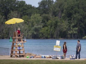 A life guard keeps an eye on swimmers at Sand Point Beach on Saturday, July 3, 2021.