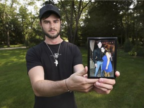 Separated by a border and a pandemic. Clay Shepley holds a photo of his American girlfriend and himself at his Harrow area home on Monday, July 5, 2021. Reuniting with his girlfriend throughout the pandemic has been difficult due to tight border restrictions.